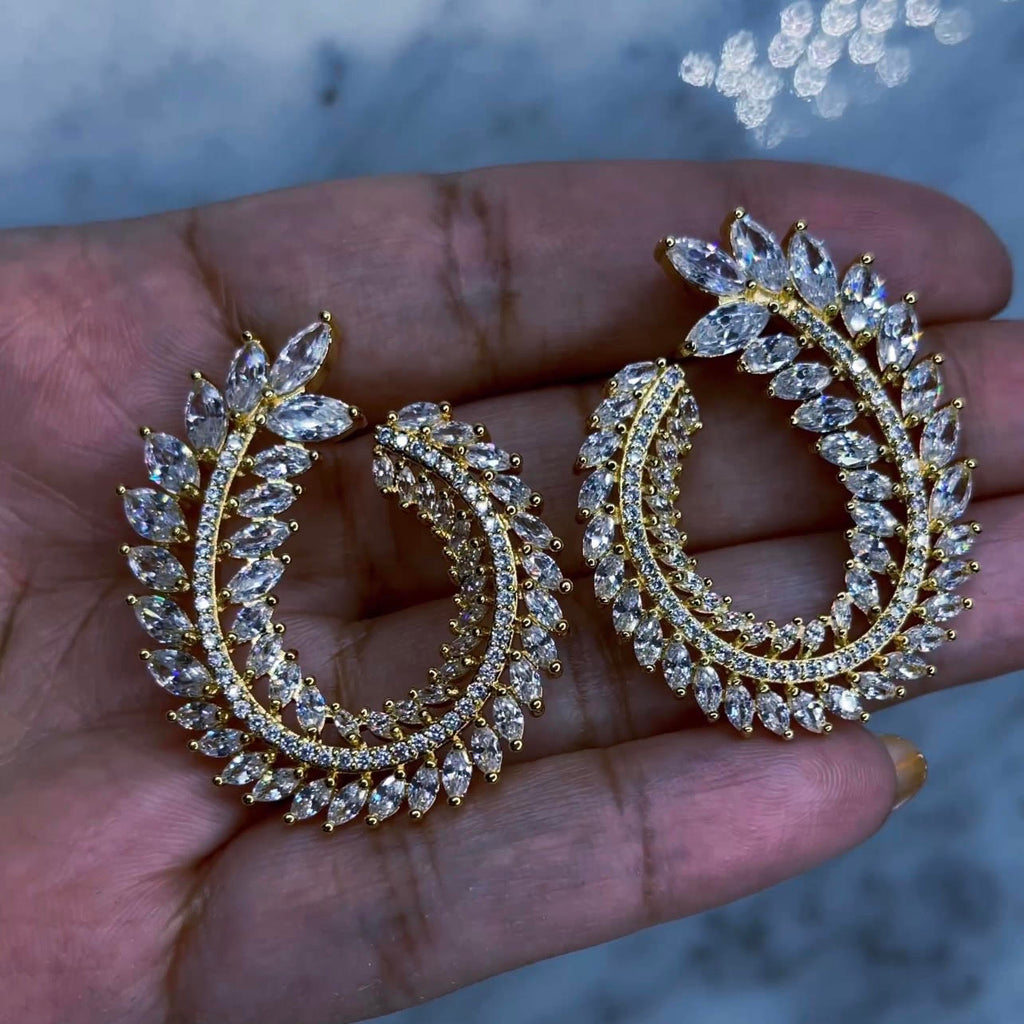 Hoja - Diamond Earrings These earrings are like art! 1 1/2" in length and 1" wide with varying size marquise cut, AAA CZ stones and emerald cut AAA CZ stones wrapping around to form an oval leaf pattern. Tarnish free and water resistant with a push back earring post