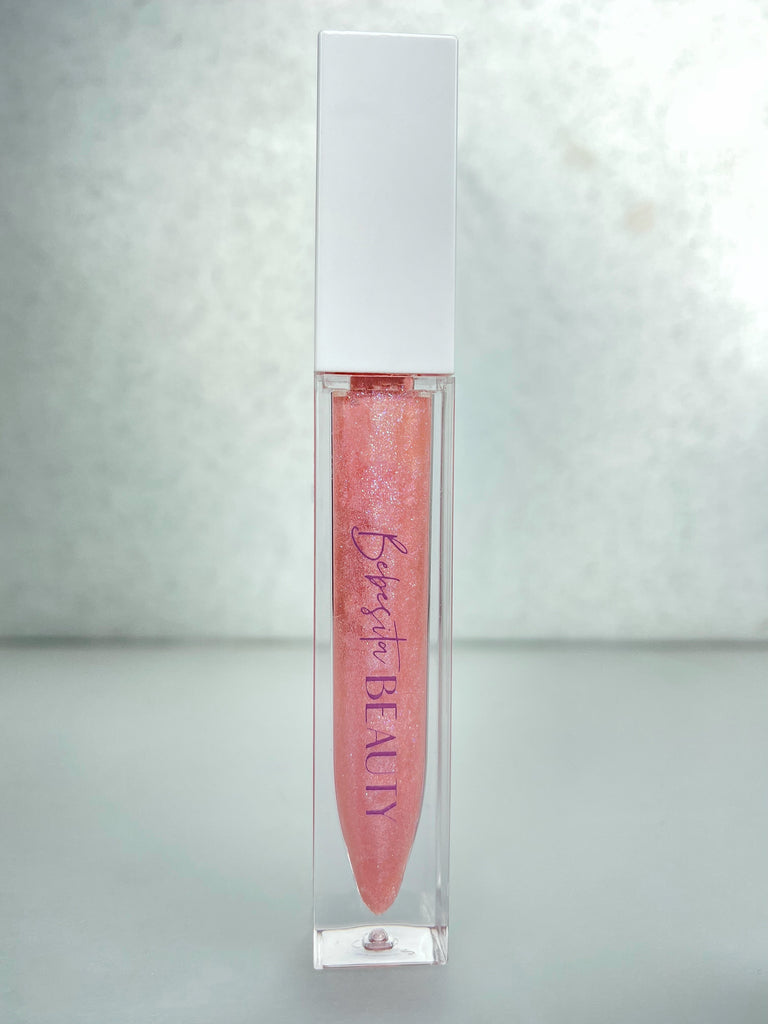 Shine bright like a diamond in Diamante! It's the buttery smooth, multi-dimensional, glittery shine you'll love. Diamante is the perfect gloss to wear alone for a soft, natural shine or layer it over your favorite lipstick for a sexy pop of shimmer!   Lightly tinted, sheer pink gloss with hints of soft pink and iridescent sparkles...