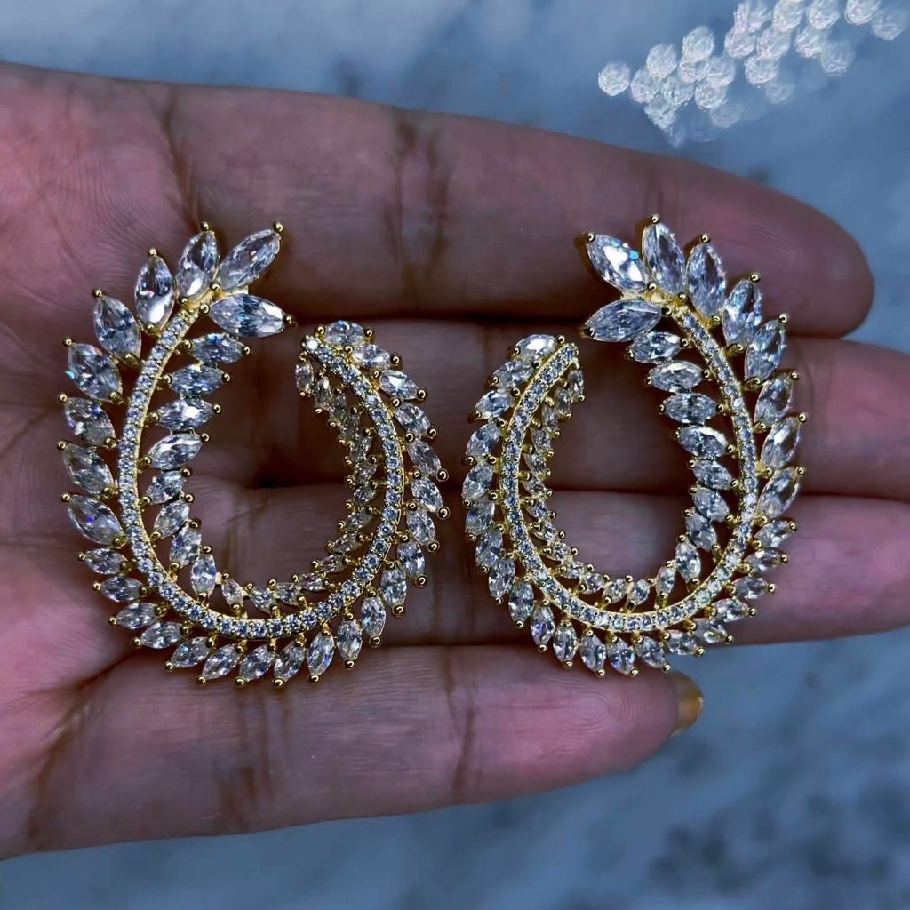 Hoja - Diamond Earrings These earrings are like art! 1 1/2" in length and 1" wide with varying size marquise cut, AAA CZ stones and emerald cut AAA CZ stones wrapping around to form an oval leaf pattern. Tarnish free and water resistant with a push back earring post